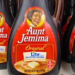 : Aunt Jemima Original Lite syrup in famous plastic bottles on a shelf.