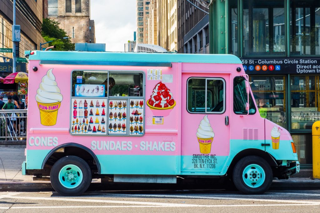 Pink and blue Ice Cream Truck on streets of Manhattan. Cones, Sundaes, Ice-cream and Shakes seller