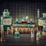 Glass bottles, old books on table of a scientist. Medicine, chemistry, pharmacy, apothecary, alchemy history background. Translation from labels-eyewash astringent, morphine hydrochloride and almonds.