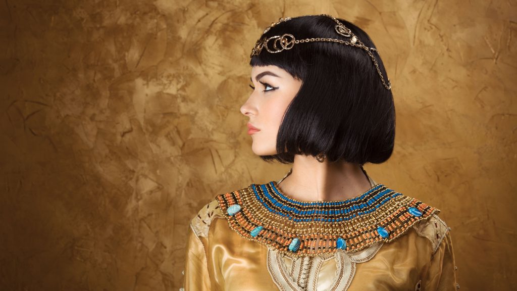 Fashion Stylish Beauty Portrait with Black Short Haircut and Professional Make-Up of Cleopatra. Beautiful Girl's Face Close-up.