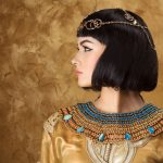 Fashion Stylish Beauty Portrait with Black Short Haircut and Professional Make-Up of Cleopatra. Beautiful Girl's Face Close-up.