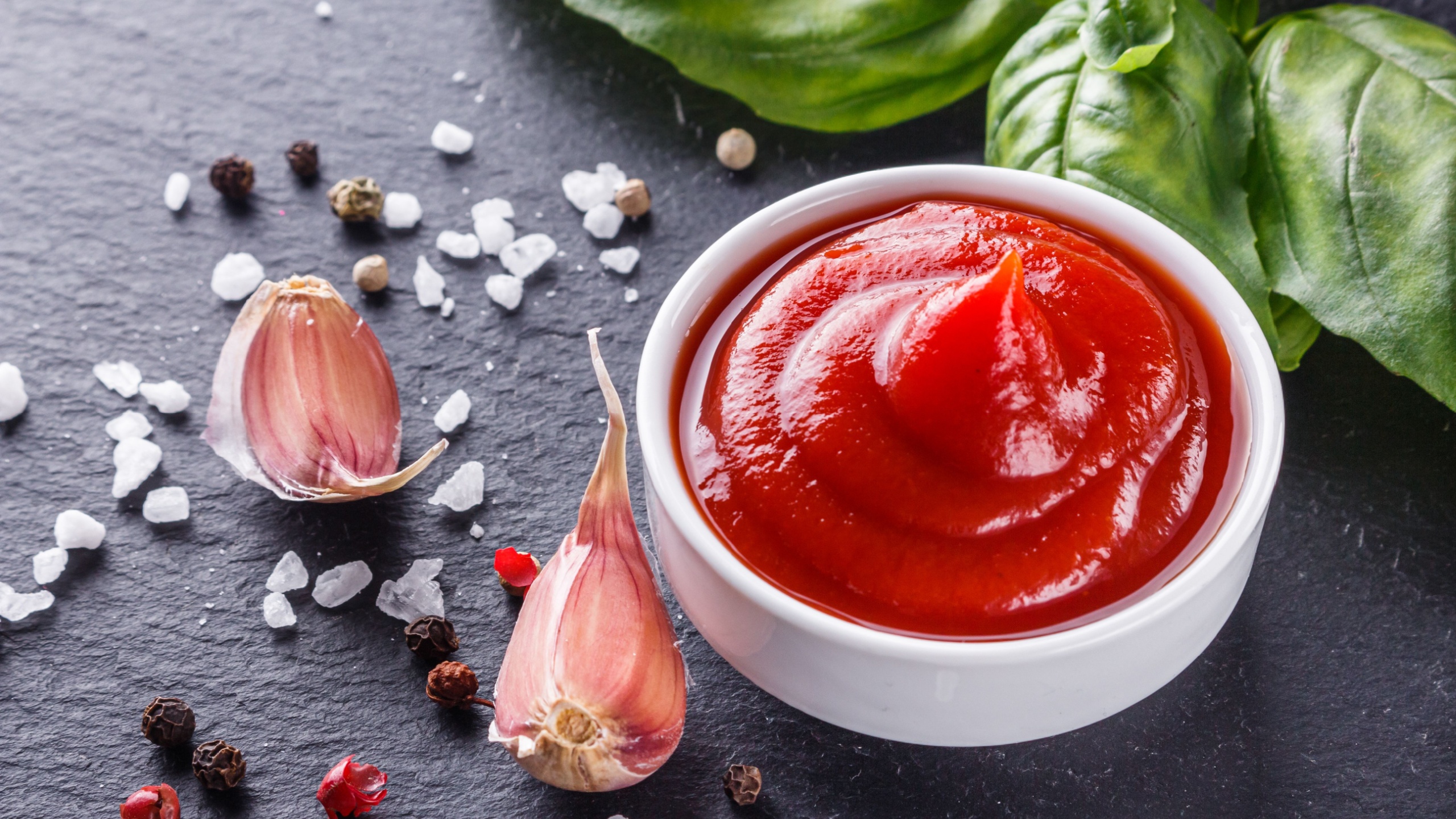 Fresh natural tomato ketchup on stone background