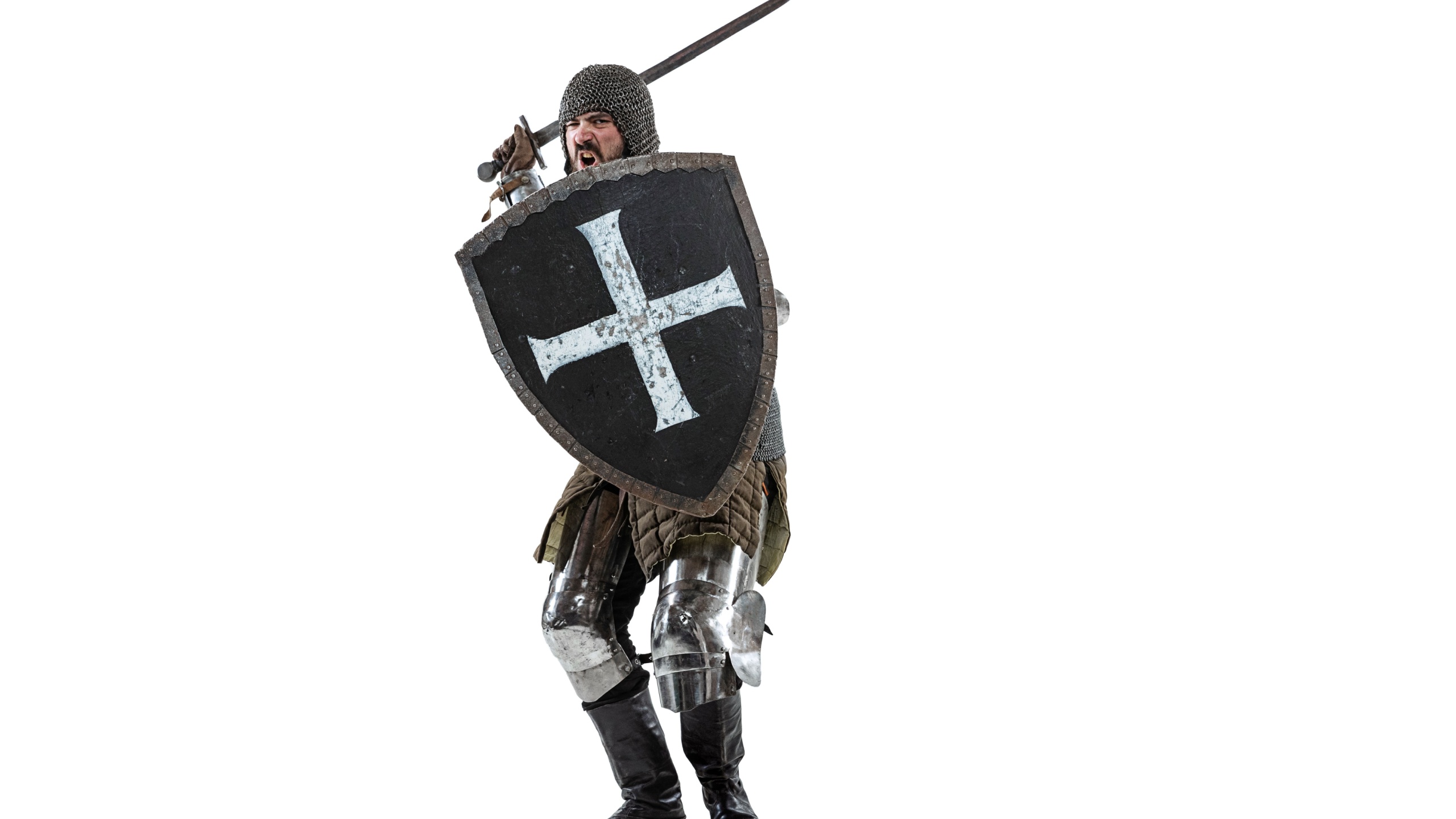 Portrait of brutal serious man, medieval warrior or knight in protective covering with sword preparing to attack isolated over white studio background. Comparison of eras, history, renaissance style