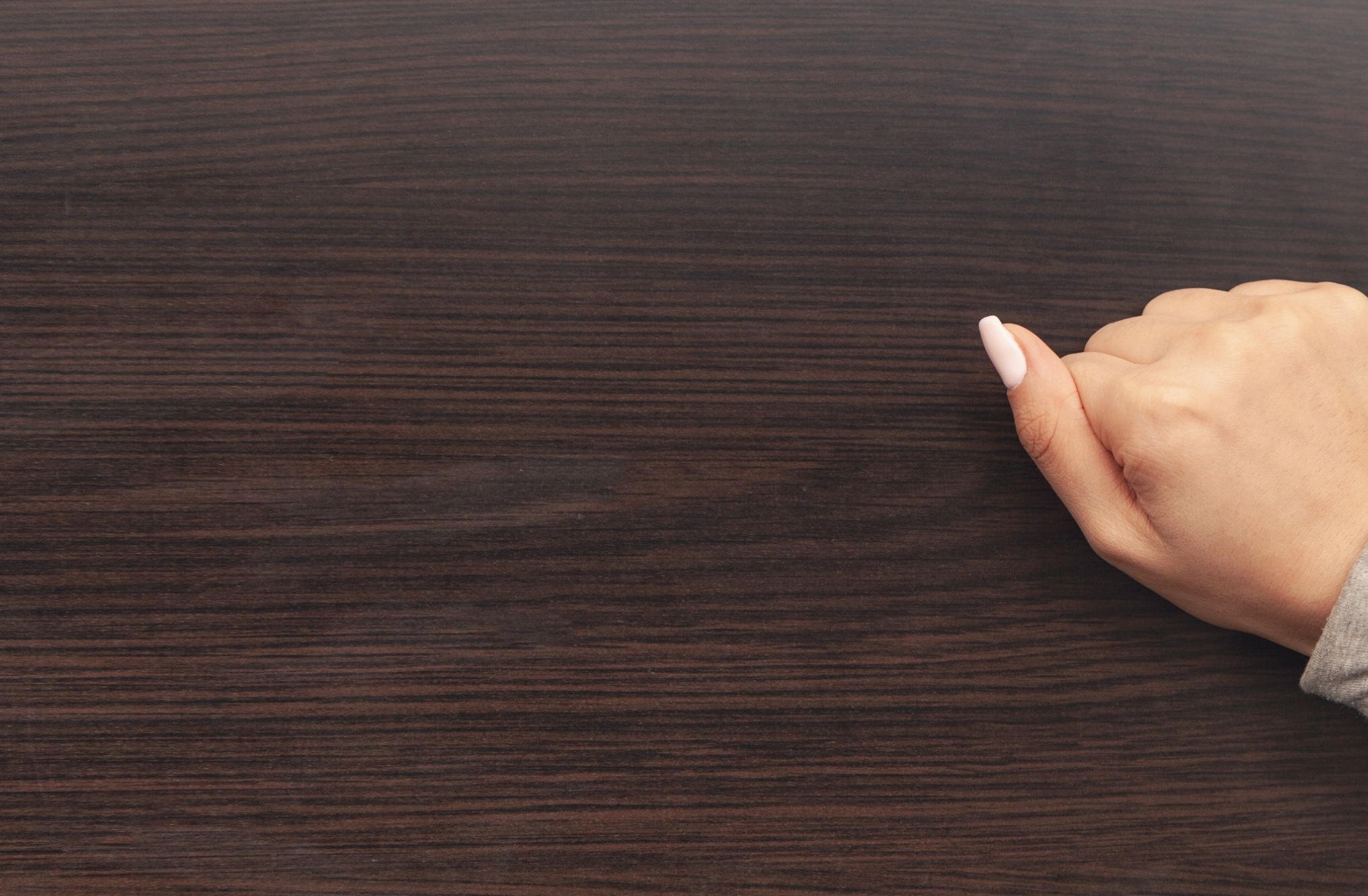 Female hand is knocking on the door.