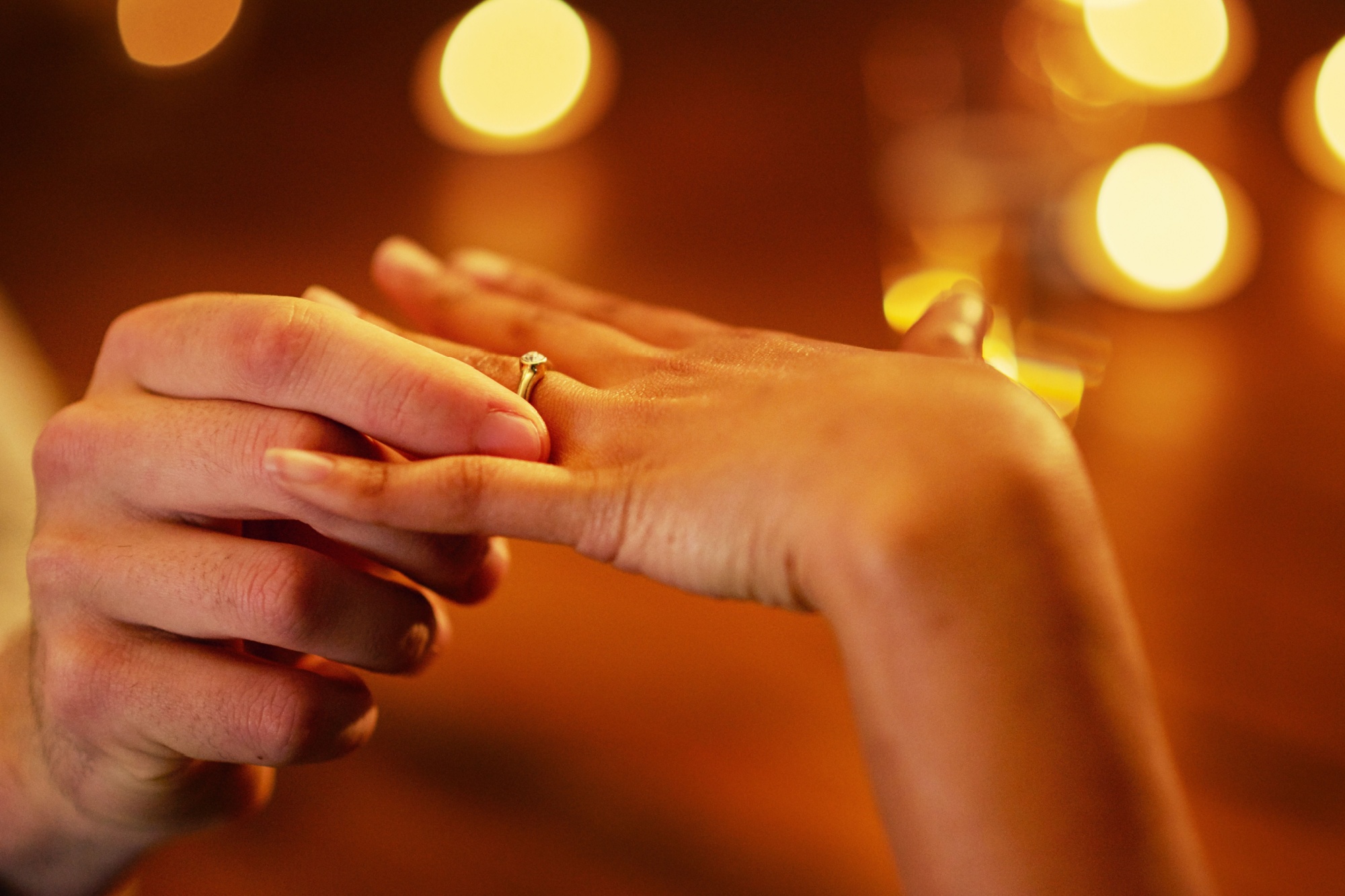 Hands, couple and engagement ring for proposal with fiance for love with commitment, people and unity. Romantic, surprise and special moment with save the date or flare, relationship and together.