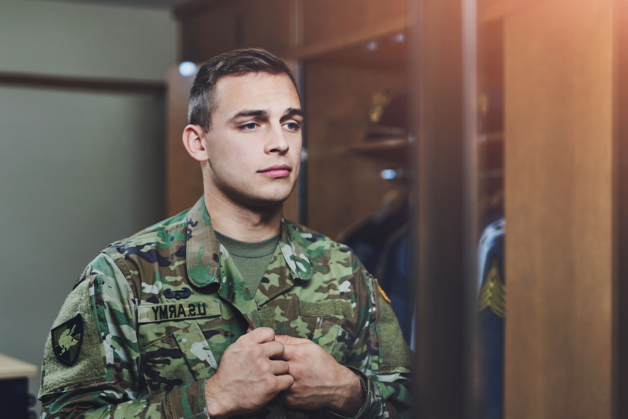 Man, army and soldier in home, uniform and duty for pride, respect and country in ready for deployment. Male person, war and hero in barracks with service, camouflage and mirror as recruit or patriot