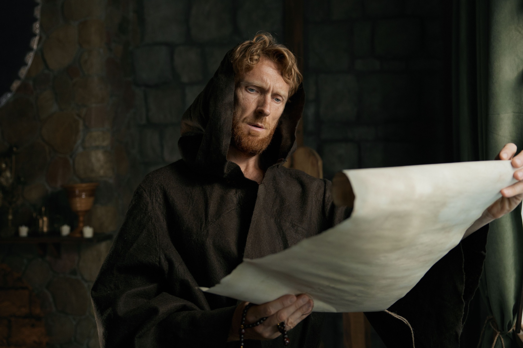 Medieval monk reading obsolete historical parchments and holy manuscripts
