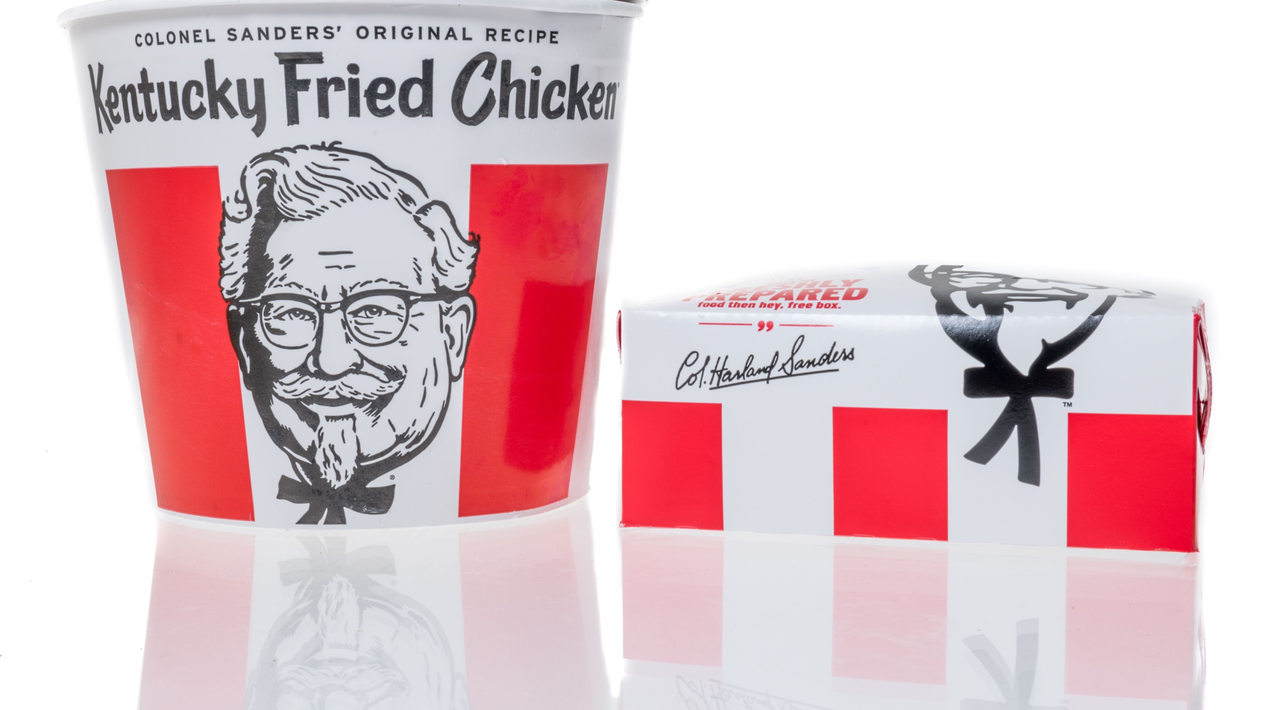 Winneconne, WI - 20 June 2021: A package of KFC Kentucky Fried Chicken bucket with biscuits colonel sanders on an isolated background