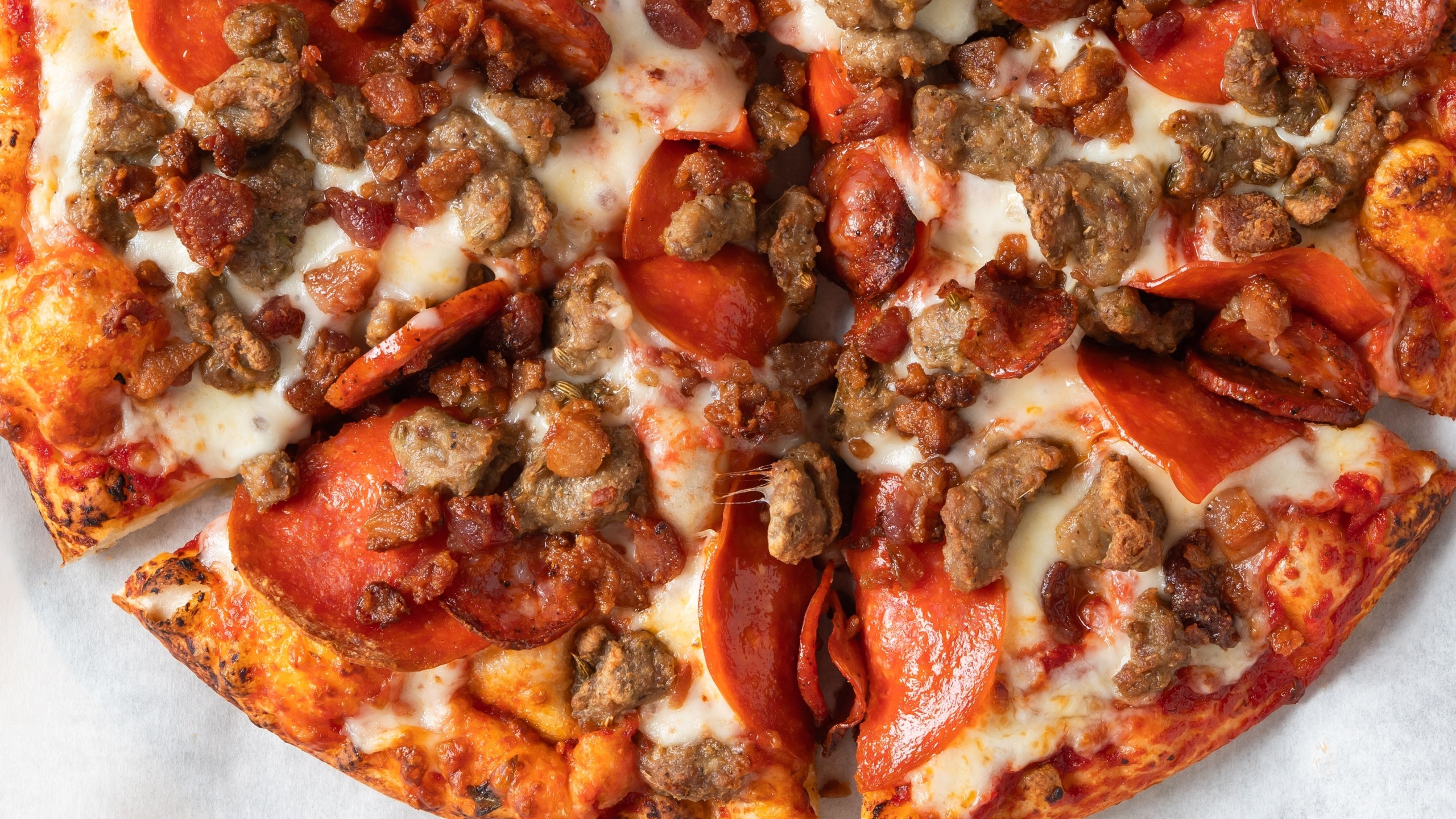 Hearty meat lovers pizza loaded with pepperoni, sausage, bacon, and melted cheese.