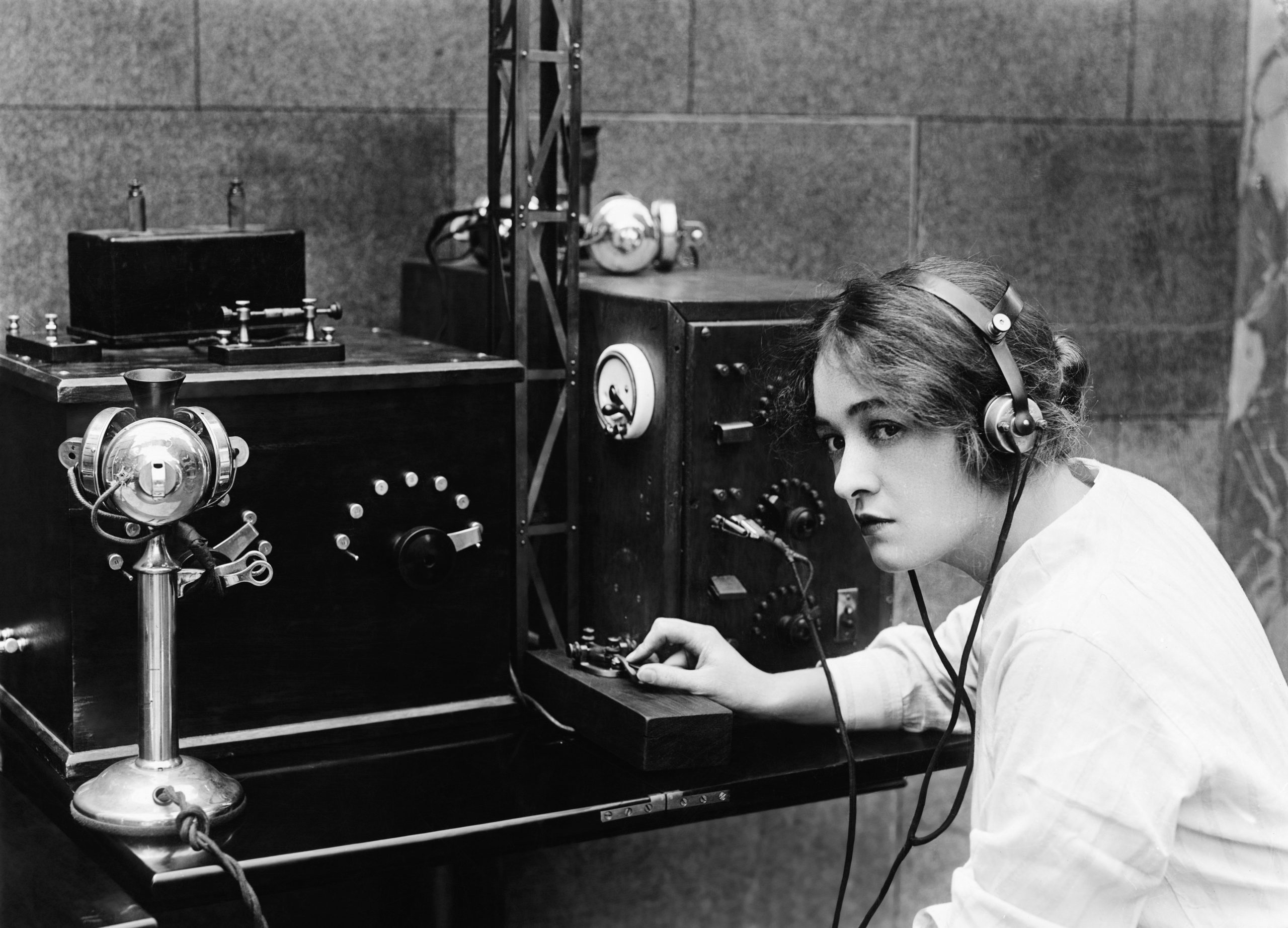 Woman sending Morse code using telegraph