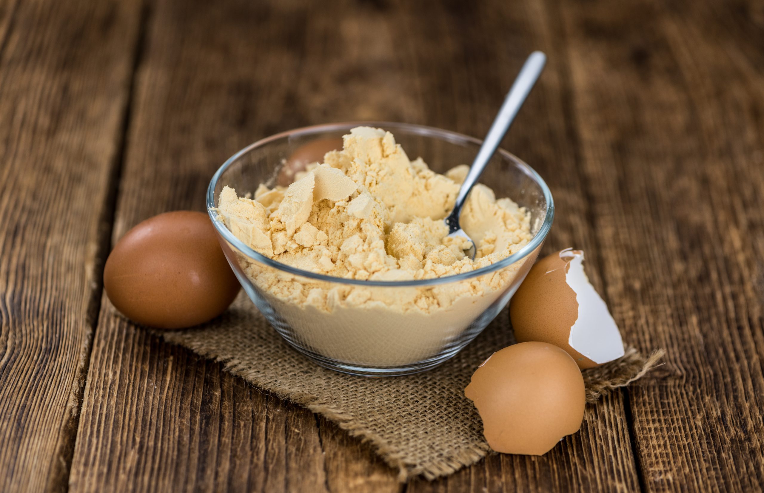 Vintage wooden table with Powdered Eggs (selective focus; close-up shot)