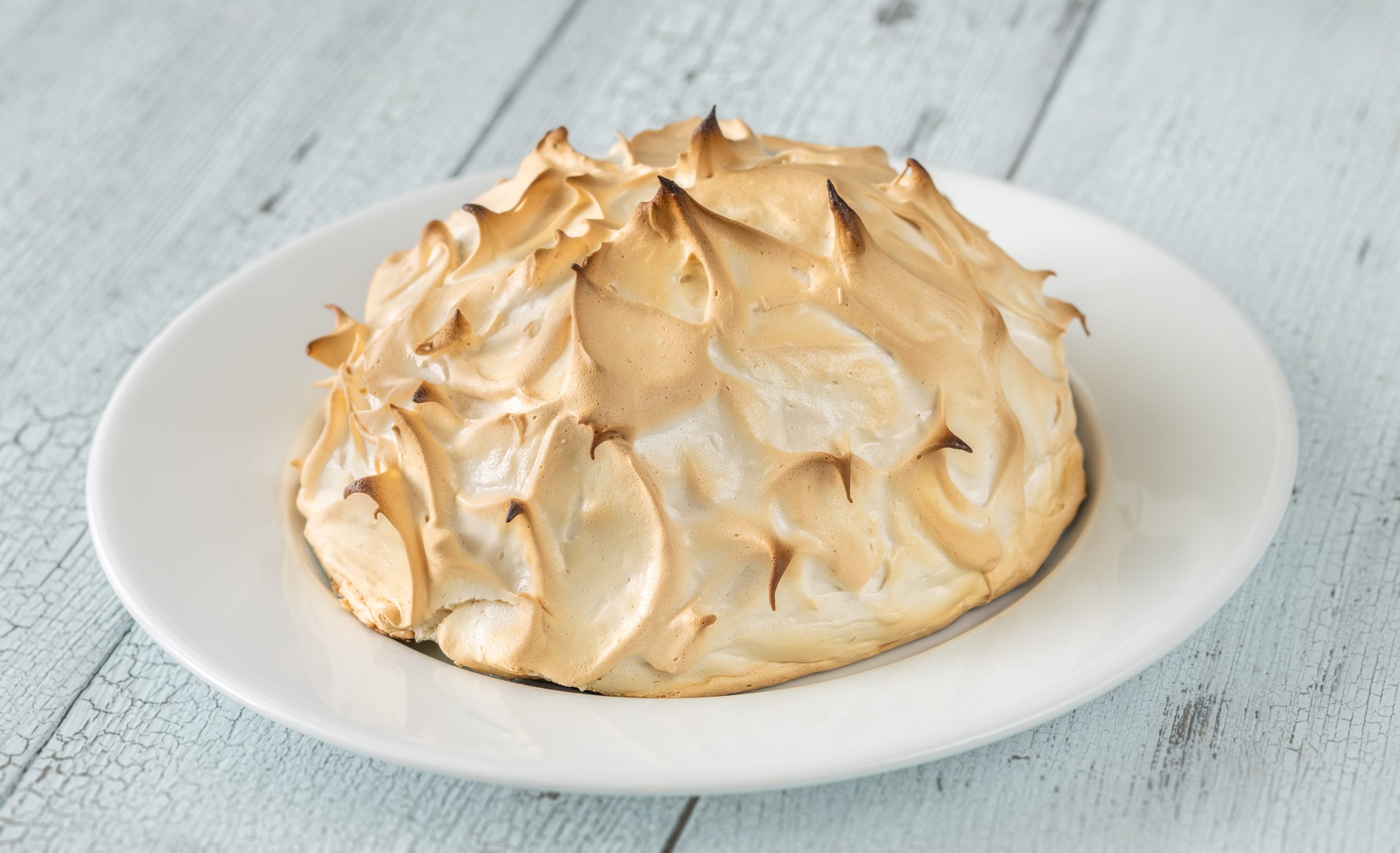 Baked Alaska dessert consisting of ice cream and browned meringue