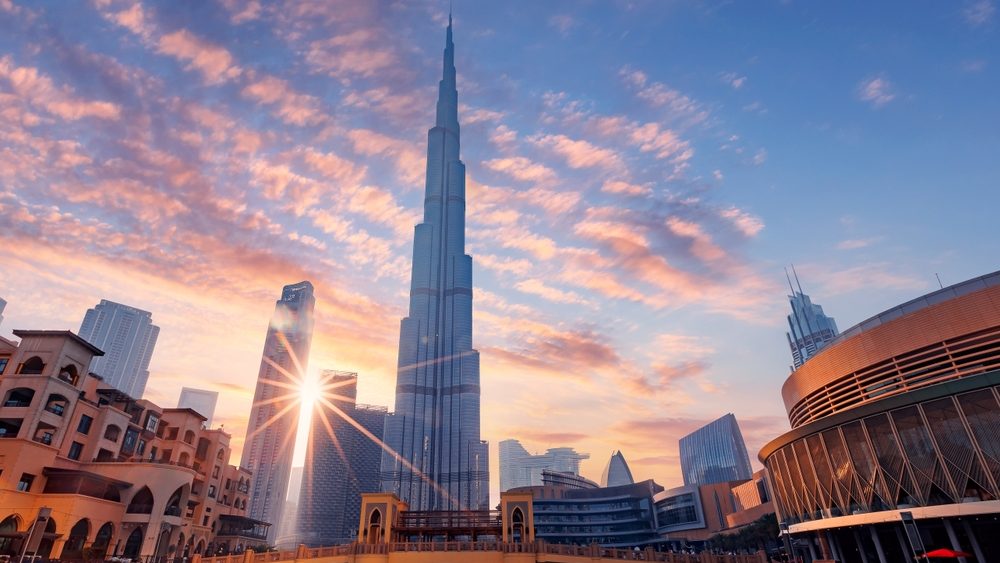 Cityscape Dubai panorama, Famous tourist landmark of city, sunset time. Modern center skyscrapers of UAE, sun light.