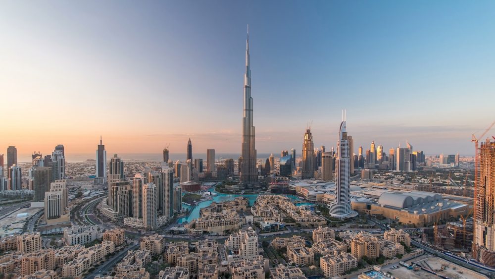 Dubai Downtown day to night transition timelapse with Burj Khalifa and other towers view from the top before new year celebration in Dubai, United Arab Emirates. Lights turning on.