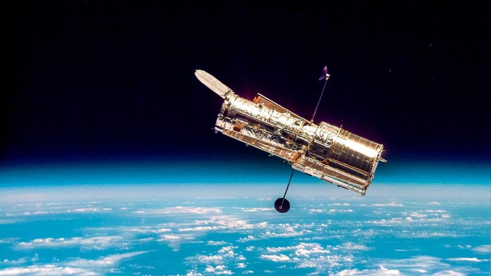 The Hubble Space Telescope hovers at the boundary of Earth and space.