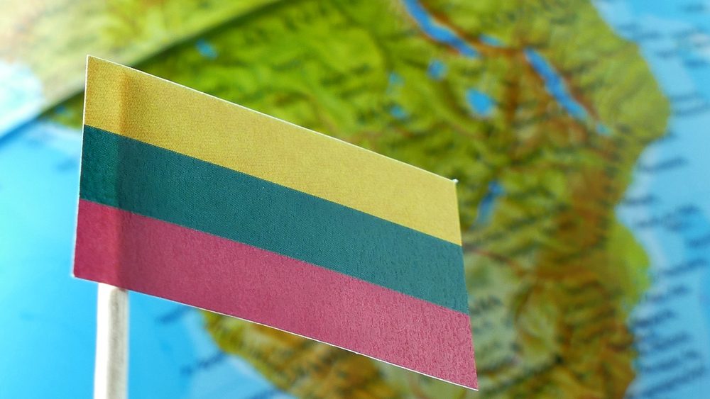 Lithuania flag with a globe map as a background macro